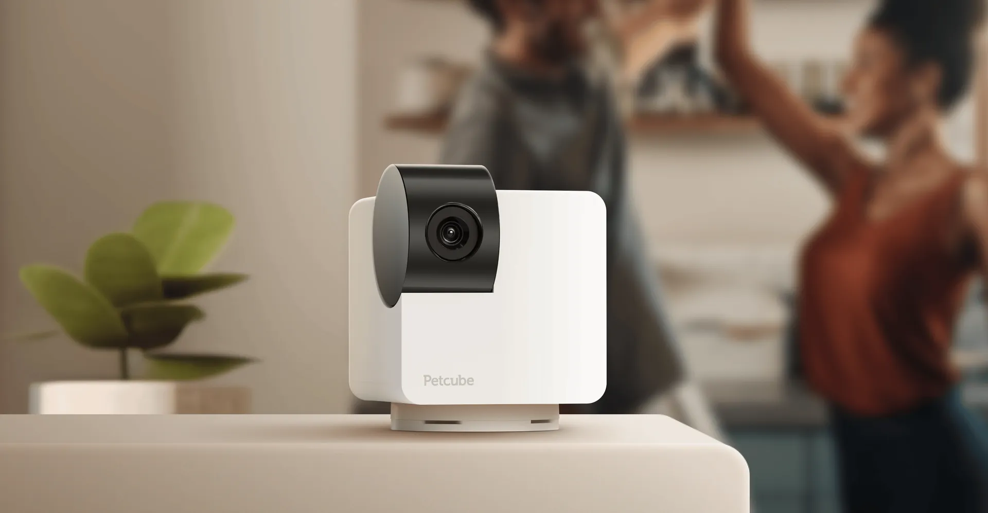 White Petcube Cam 360 camera on a shelf