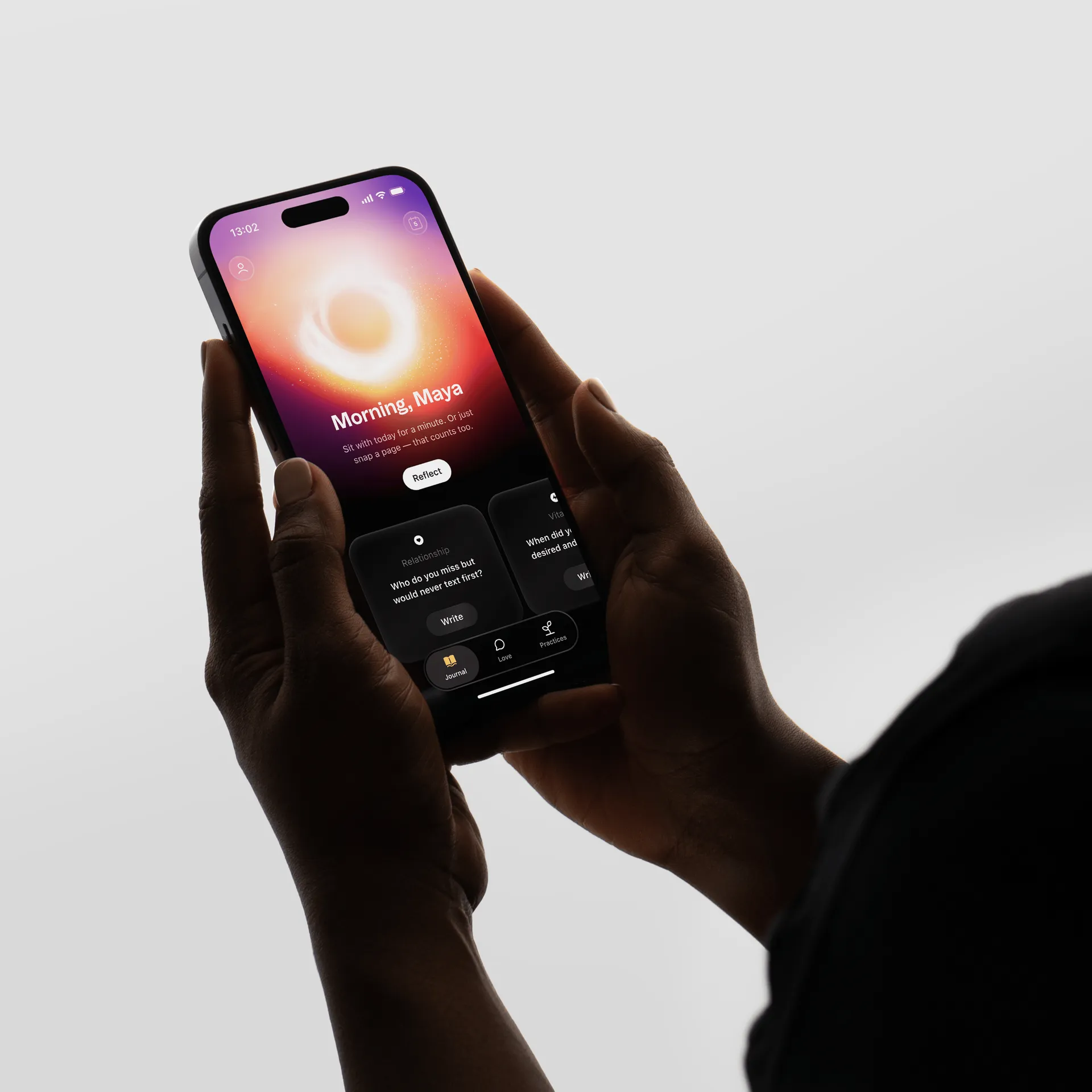 Hand holding a phone running the Goodly app