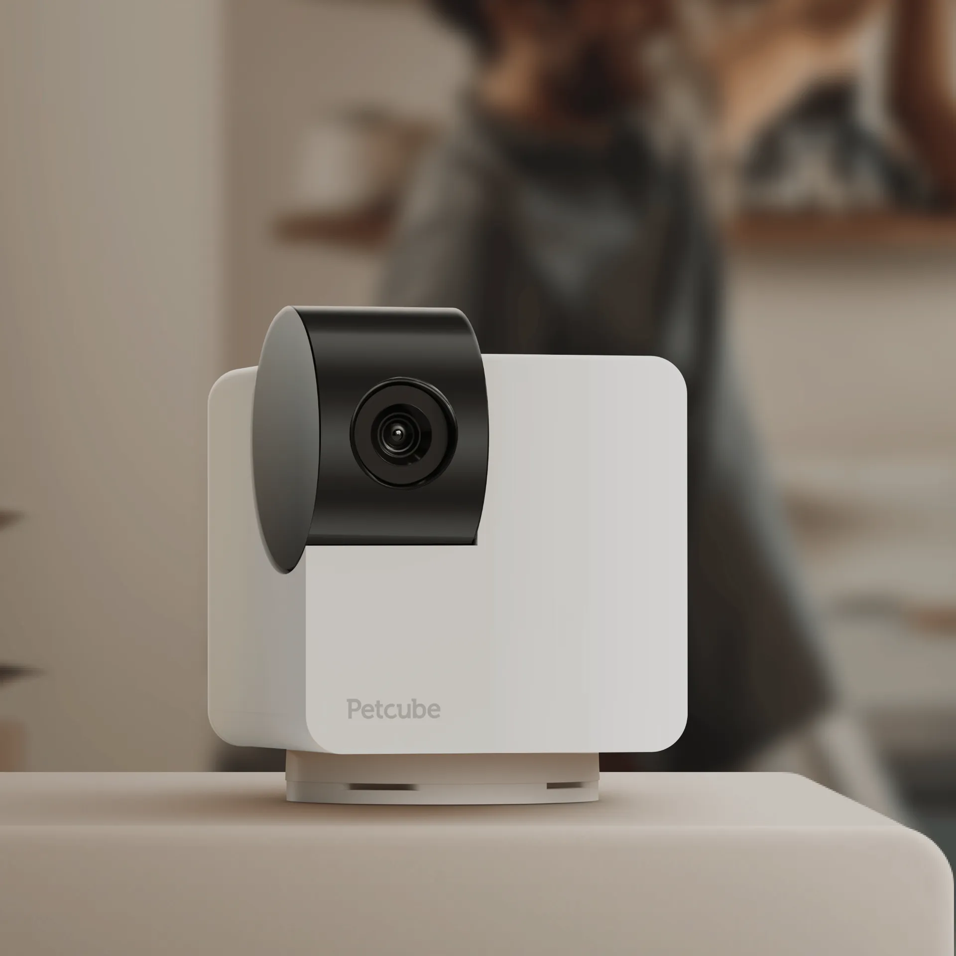 White Petcube Cam 360 camera on a shelf