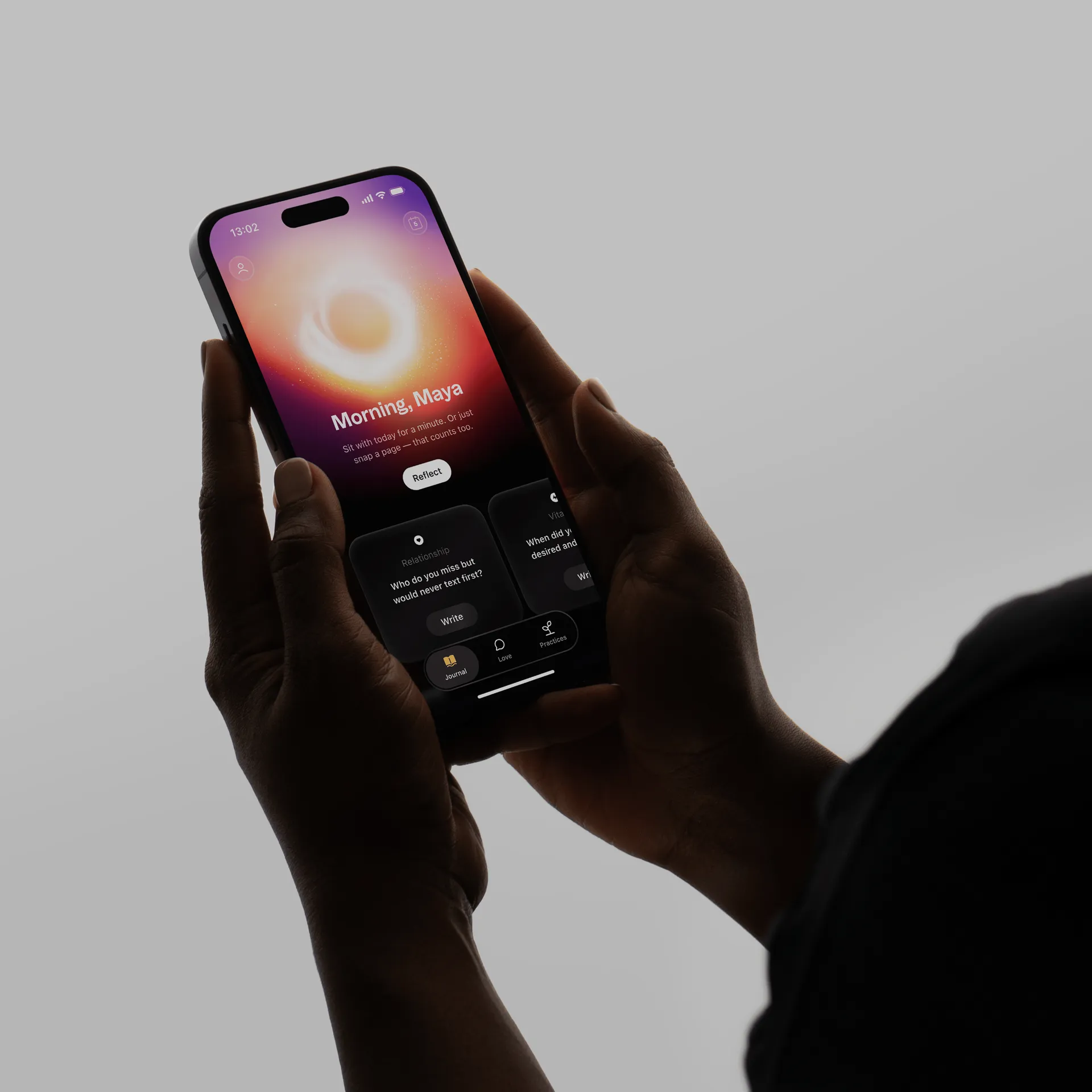 Hand holding a phone running the Goodly app